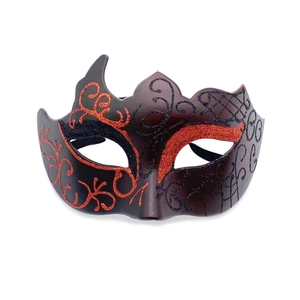 Detailed view of half-face masquerade mask with black base and red glitter patterns