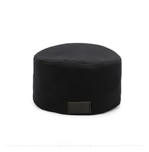 Detail view of the black cotton cadet cap back featuring a brown leather star logo patch