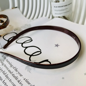 Detail of dark tortoiseshell acetate headband on a stylish magazine background