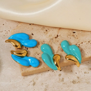 Detailed view of teardrop wave earrings in sky blue and turquoise on stone background