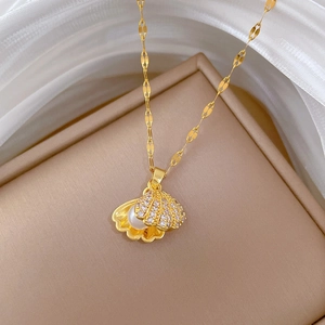 Detail of shell pendant necklace with pearl and sparkling cubic zirconia on jewelry box