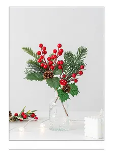 Close-up of Christmas decorative branch with red berries, pine cones and mini mushroom