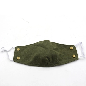 Detailed view of dark green corduroy winter face mask with four decorative bronze buttons