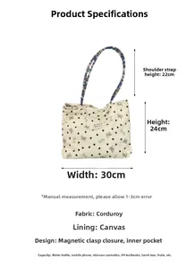 Detailed view of corduroy tote bag dimensions with black bow and heart patterns