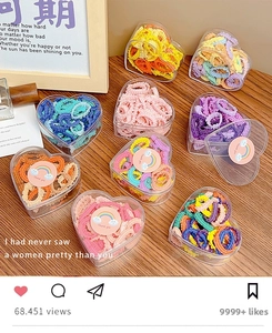 Macro detail of colorful elastic hair bands in a transparent heart-shaped box