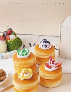 Detailed macro view of assorted PU simulation soufflé cake models with berry toppings