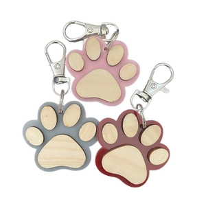 Wooden paw print keychains with acrylic frames in pink, grey, and burgundy colors