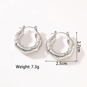 Detailed view of silver twisted hoop earrings with thick spiral texture and pin clasp