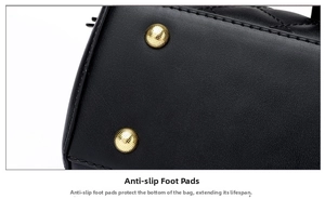 Close-up of black quilted leather bucket bag bottom with protective gold metal studs