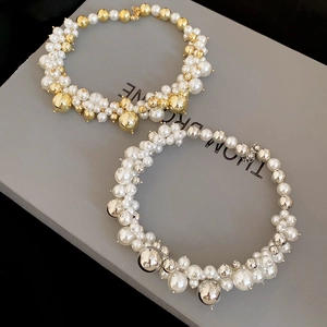 Detail of irregular pearl and metal bead necklaces in gold and silver finishes