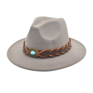 Detail of wool fedora hat featuring brown leather band and turquoise stone accent