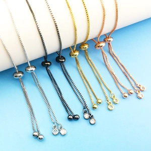 Adjustable rhinestone bracelets in gold and silver finish on a white display stand
