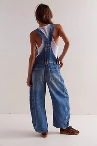 Back view of vintage washed blue denim overalls with loose straight leg fit for street style