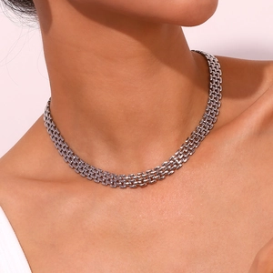 Macro detail of high-quality silver braided strap chain necklace on a model