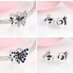 Detailed macro of S925 sterling silver butterfly charms with blue and white crystals