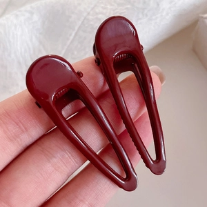 Minimalist dark red geometric hair clips with hollow waterdrop design in a set of two