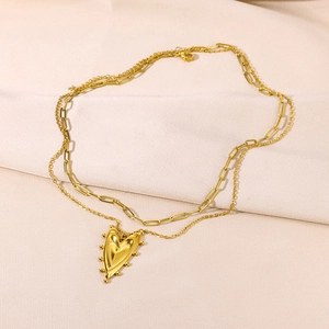 Detailed close-up of a double-layered 18K gold plated heart pendant with paperclip chain