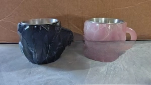 Detail of coffee mugs featuring geometric crystal facets in black and pink resin finish