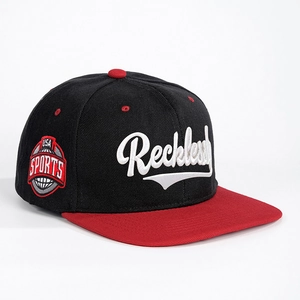 Classic black snapback hat with red brim and Reckless script embroidery on front