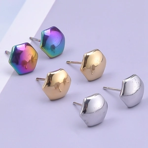 Detail of hexagonal geometric stud earrings in rainbow, gold, and silver stainless steel