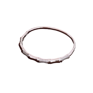 Silver-plated bamboo-shaped bangle with sparkling zircon pavé on white background