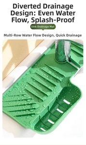 Close-up of green silicone faucet mat showing drainage ribs and storage basket for sinks