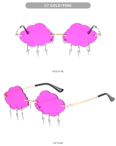 Close-up of cloud-shaped rimless sunglasses with gold frames and lightning pendants