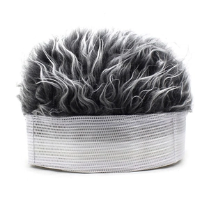 Macro shot of grey-black curly wig hair attached to a white sun visor baseball cap