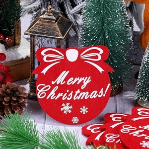 Macro detail of red Christmas felt coaster with white bow and Merry Christmas text