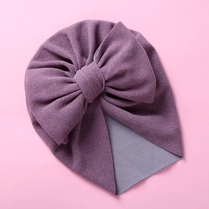 Detail of soft purple newborn turban hat featuring a large double layered bow knot