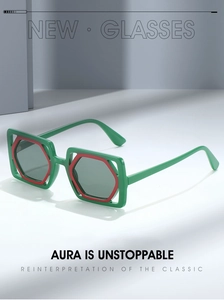 Detail of square oversized sunglasses featuring bold green and red layered color-blocking frames