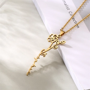 Close-up of golden stainless steel necklace with floral mama pendant on white card