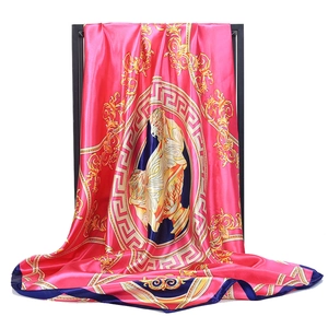 Artistic drape of pink silk scarf with gold paisley patterns and baroque medallion motif