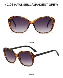 Close-up of tortoiseshell oversized sunglasses with gradient grey lenses and black temples