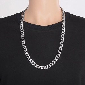 Detailed view of a silver 11.5mm wide curb chain necklace at 76cm length on a black shirt