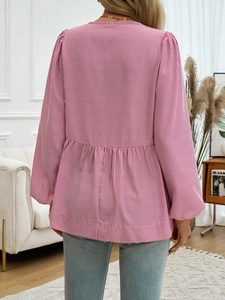 Detail showing the back of pink striped puff sleeve blouse with pleated design and tie-back