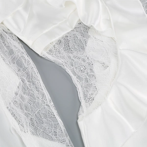 Macro shot of white lace and silky satin fabric detailing on an elegant women's dress