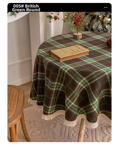 Detail of British green plaid round tablecloth with elegant white fringe tassel edges
