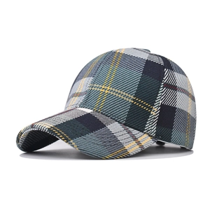 Detailed view of thick houndstooth plaid baseball cap with green and yellow weave texture