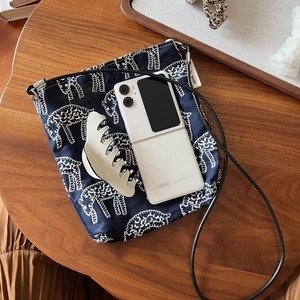 Artistic navy denim crossbody phone bag with embroidered white sheep patterns