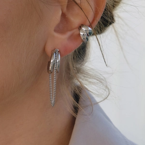 Silver hollow double-layer ear cuff and chain earring set on model's ear