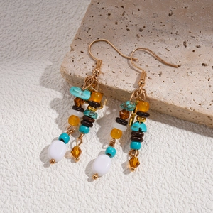 Detail of bohemian beaded tassel earrings with star charms and natural stone beads