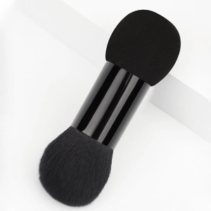 Dual-ended makeup brush with dense black fiber bristles and beauty sponge for flawless finish