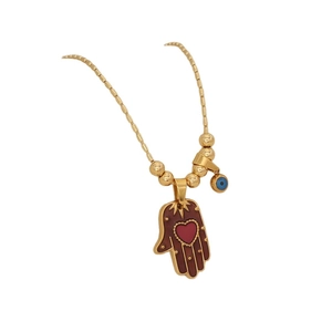 Golden Hamsa hand necklace with red heart and blue evil eye charm on white background