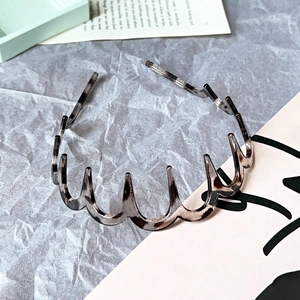 Detail showing wavy leopard print headband on a minimalist aesthetic background