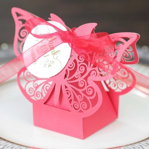 Macro shot of laser-cut butterfly candy box in magenta with Thank You tag and ribbon