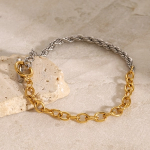 Detail of two-tone stainless steel bracelet with gold and silver links and T-bar toggle clasp