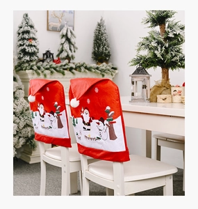 Detail of Christmas chair covers with Santa and Snowman prints in a cozy home setting