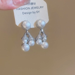 Macro detail of S925 silver needle pearl tassel earrings with zircons in elegant design