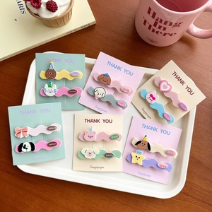 Close-up of cute cartoon animal hair clips in pastel macaron colors on display cards